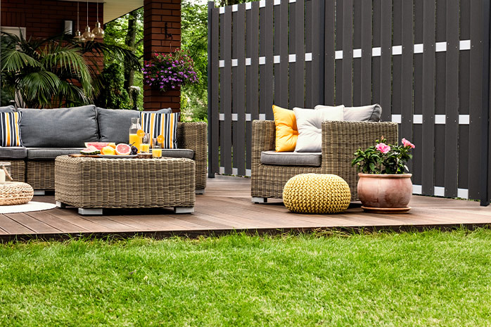 WPC terrace in the garden with seating, decoration and potted plant
