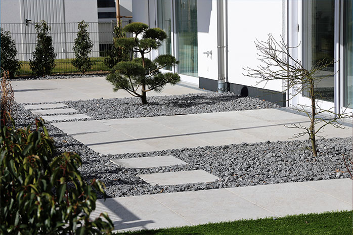 Modern terrace design with concrete, stone and sparse planting
